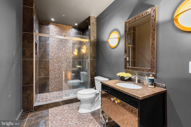 bathroom with vanity, a shower stall, toilet, and tile patterned floors