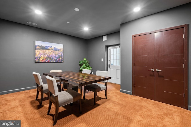 dining area featuring baseboards, visible vents, light colored carpet, and recessed lighting