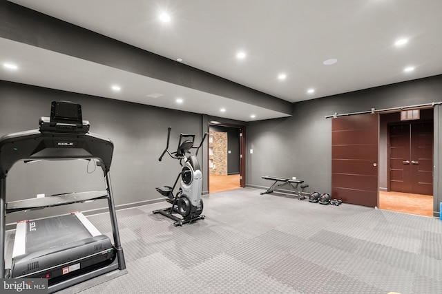 workout area featuring a barn door, baseboards, and recessed lighting