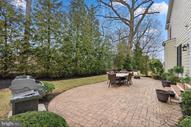 view of patio with outdoor dining area and a grill