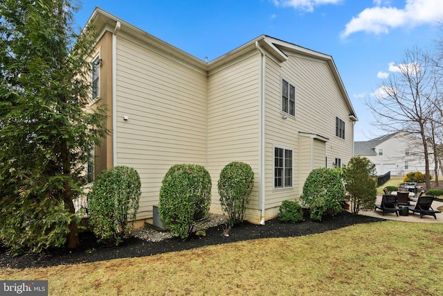 view of home's exterior with a patio and a yard