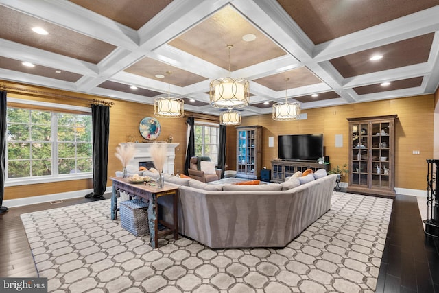 living room featuring a fireplace, baseboards, wood finished floors, and beamed ceiling