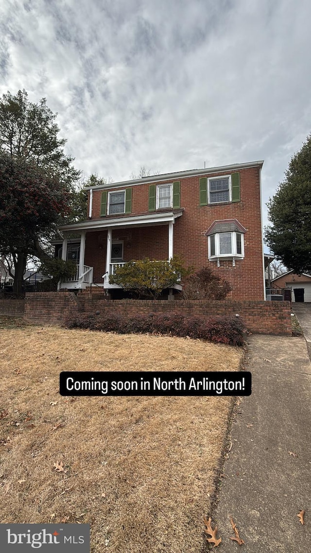 view of front of home with brick siding and covered porch