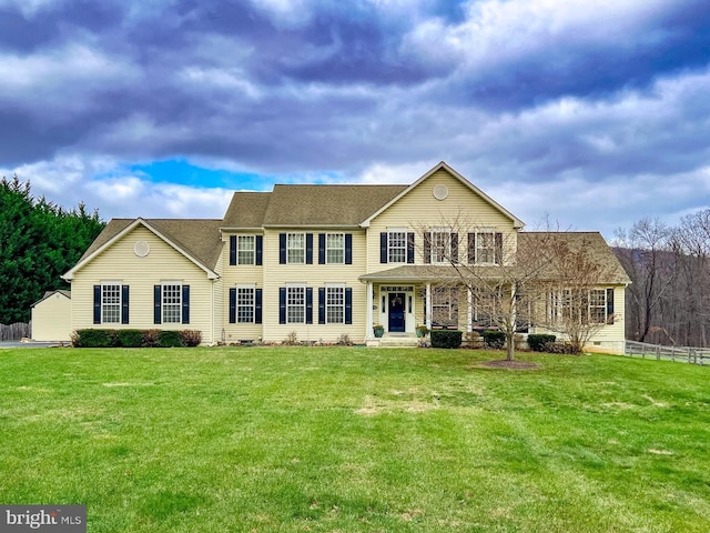 view of front of property with a front lawn and fence