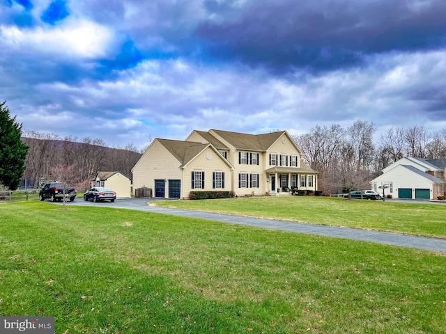 view of front of home with a garage and a front yard