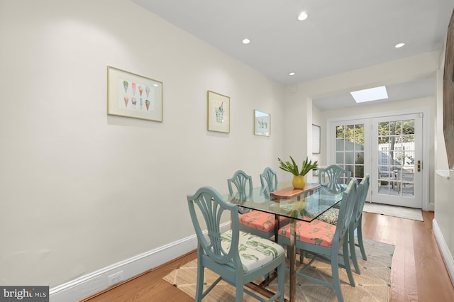 dining space featuring french doors, recessed lighting, light wood-style flooring, and baseboards