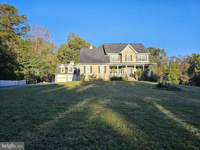 view of front of house with covered porch, a chimney, and a front yard