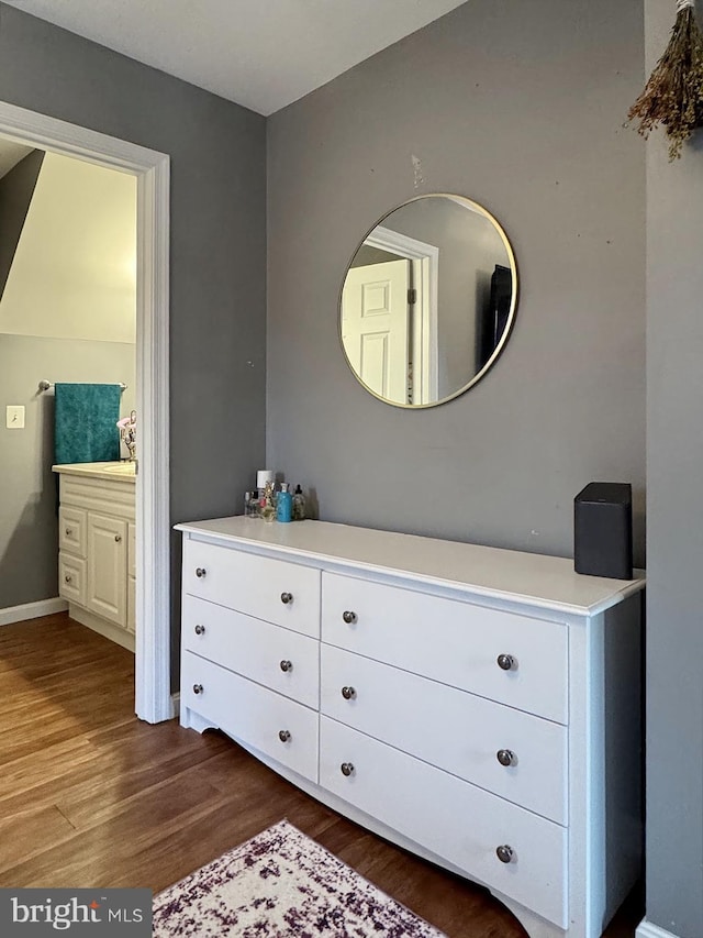 interior space with wood finished floors and baseboards