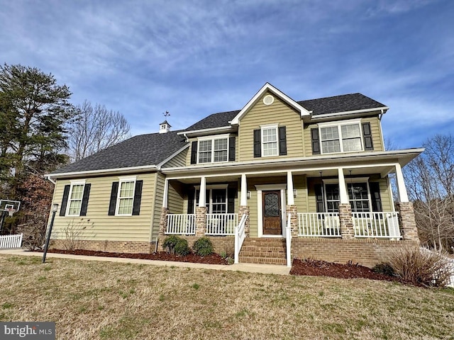 view of front of property featuring a porch, a front yard, and a shingled roof