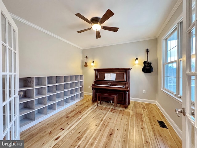 sitting room with visible vents, ornamental molding, baseboards, and hardwood / wood-style flooring