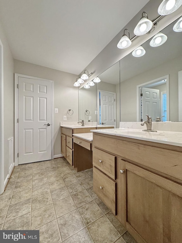 bathroom featuring vanity, tile patterned floors, and baseboards