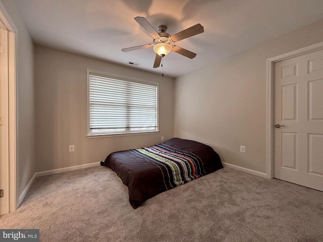 carpeted bedroom featuring baseboards, visible vents, and ceiling fan