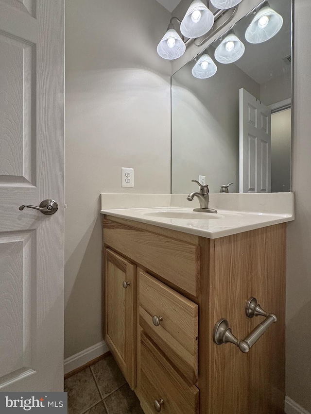 bathroom featuring vanity, tile patterned floors, and baseboards