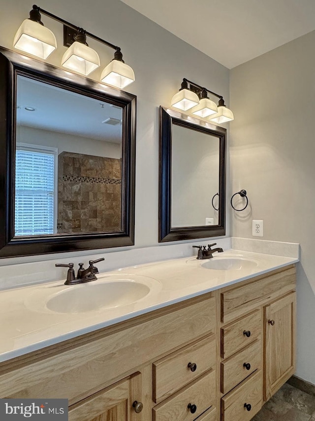 full bathroom with double vanity and a sink