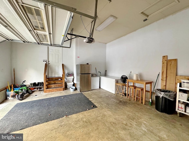 garage featuring a garage door opener and freestanding refrigerator