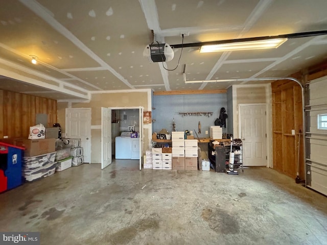 garage featuring independent washer and dryer and a garage door opener