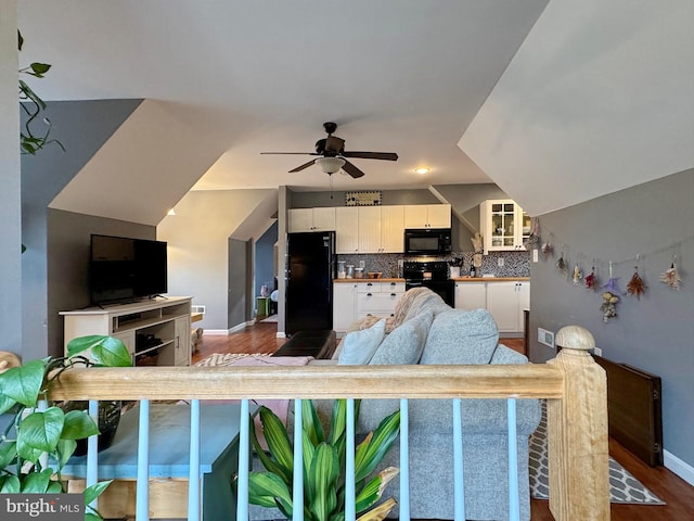 living area with dark wood finished floors, baseboards, and ceiling fan