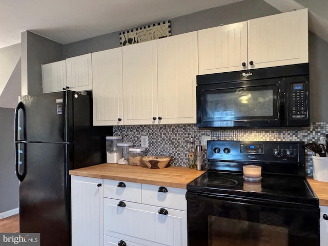 kitchen with decorative backsplash, black appliances, white cabinets, and butcher block counters