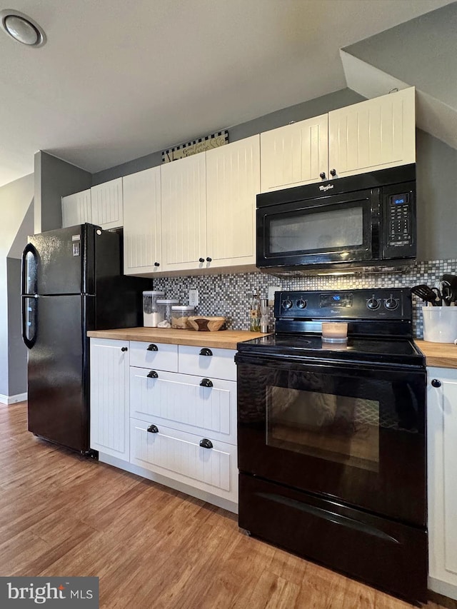 kitchen featuring decorative backsplash, black appliances, and light wood-style flooring