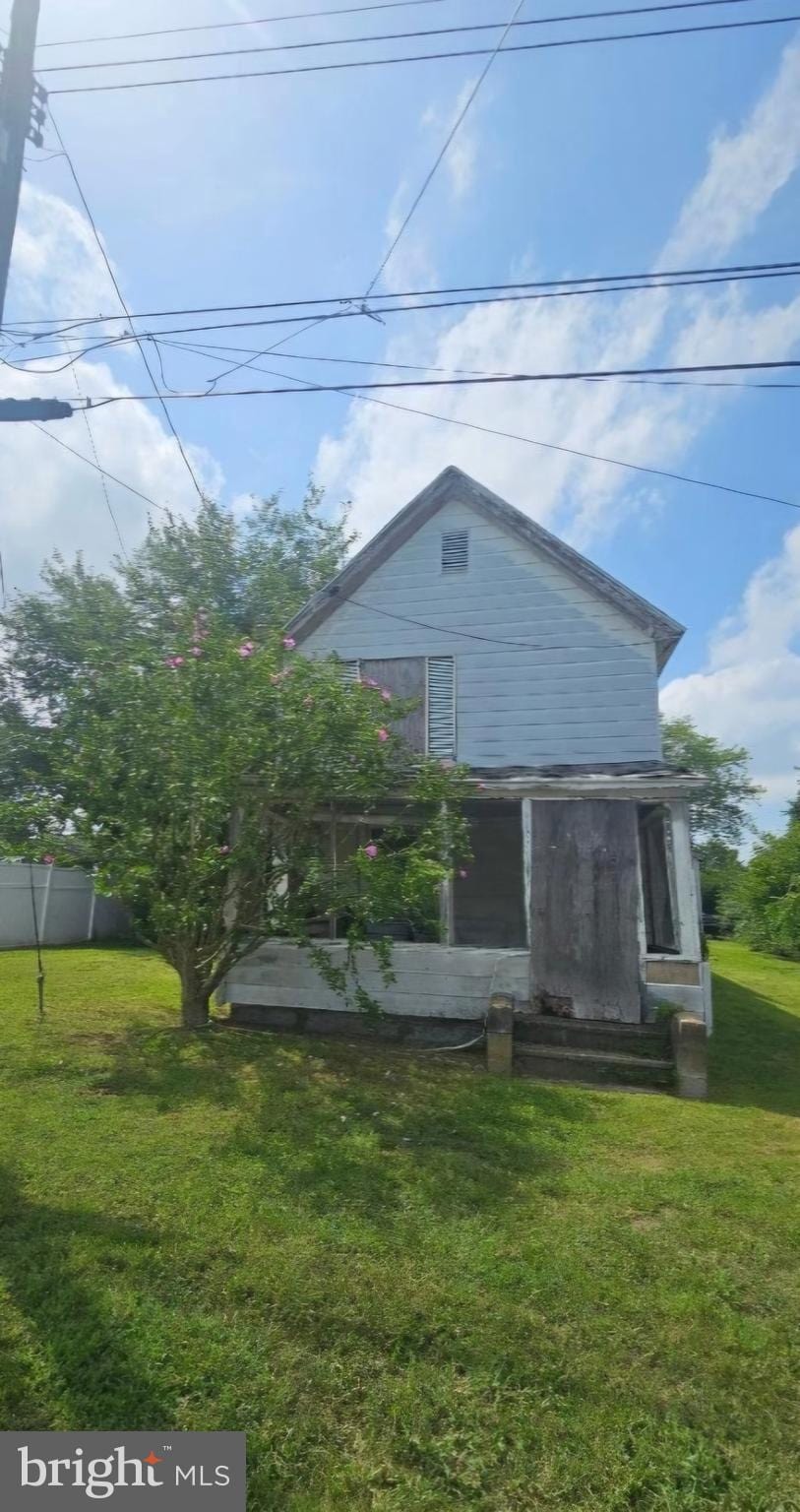 exterior space with entry steps, a yard, and fence