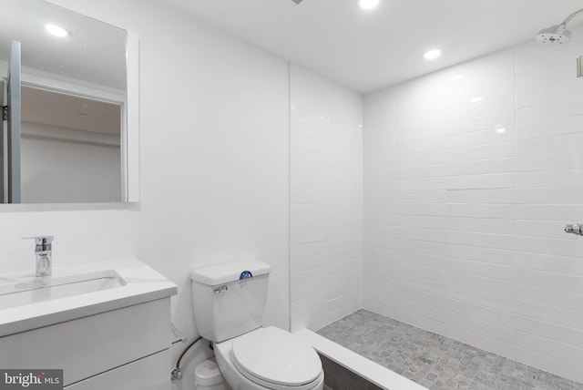 bathroom with toilet, a shower stall, recessed lighting, and vanity