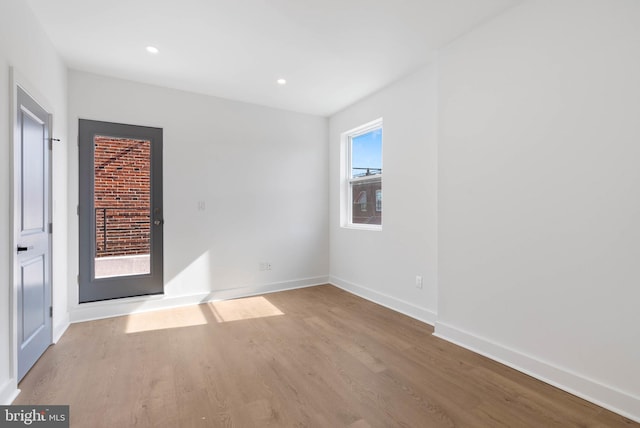 unfurnished bedroom featuring light wood finished floors, baseboards, and recessed lighting