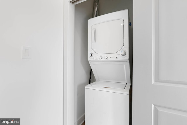 laundry area with stacked washer / dryer and laundry area