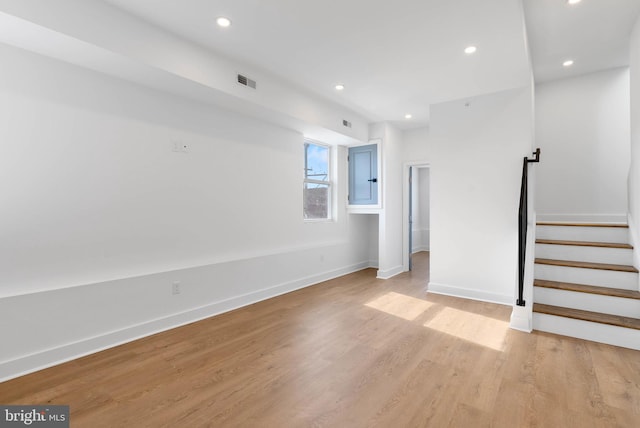 interior space featuring light wood-style flooring, recessed lighting, visible vents, baseboards, and stairs