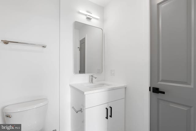 bathroom with toilet and vanity