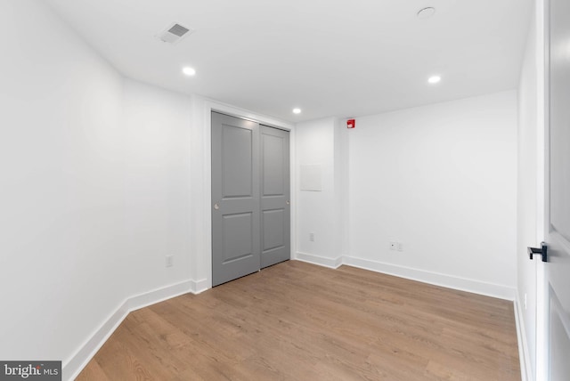 unfurnished room with light wood-style flooring, visible vents, baseboards, and recessed lighting