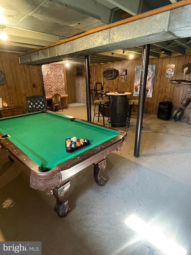 game room featuring concrete floors, wooden walls, and pool table