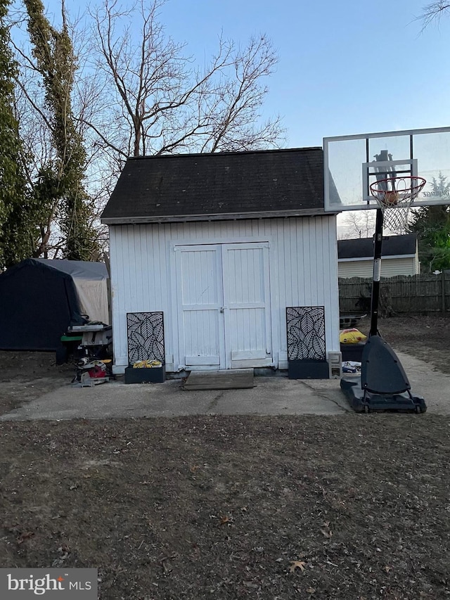 view of shed with fence