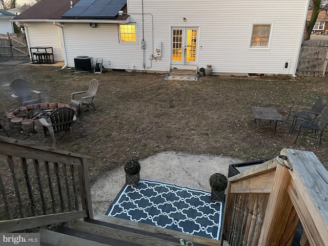 view of yard with central AC, an outdoor fire pit, and fence