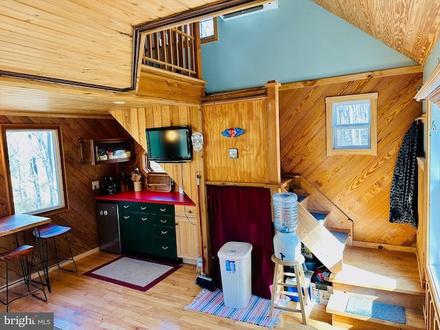 kitchen featuring wood ceiling, wood walls, light wood-style flooring, and a wealth of natural light