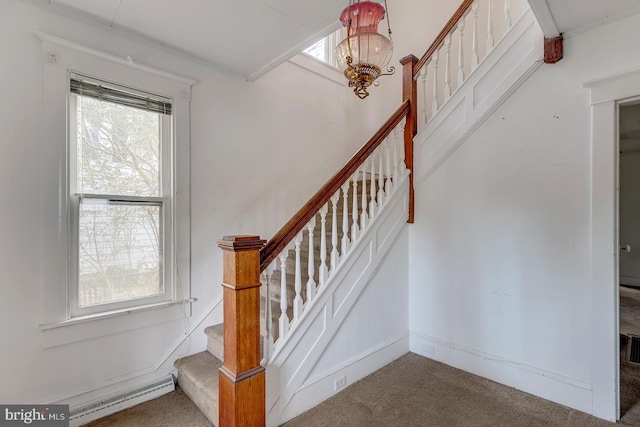 staircase featuring a baseboard radiator, carpet flooring, a wealth of natural light, and baseboards