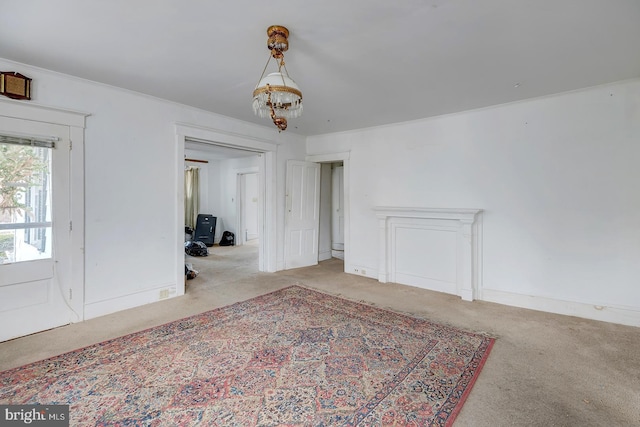 carpeted dining room featuring a chandelier, crown molding, and baseboards