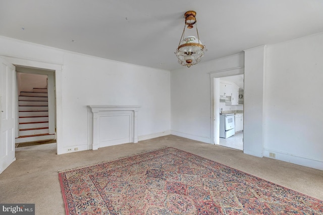 interior space featuring carpet floors, a chandelier, stairway, and baseboards