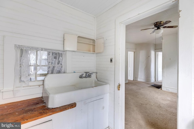 bathroom featuring ceiling fan and a sink