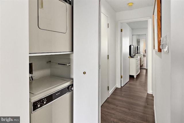 hall with stacked washer and dryer and dark wood finished floors