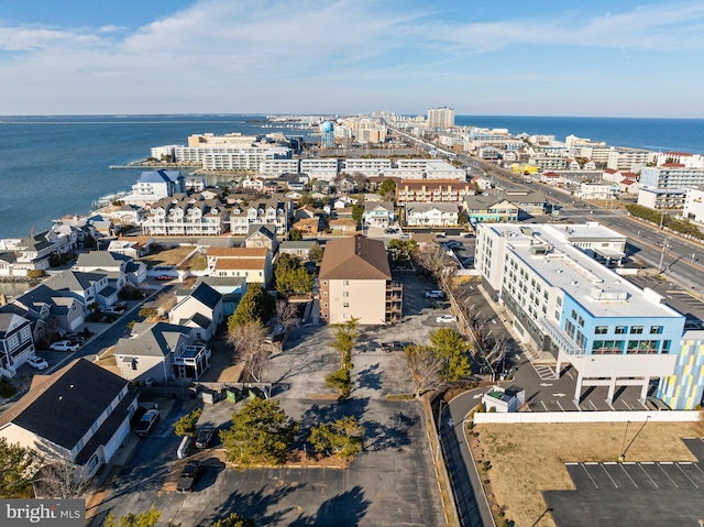 birds eye view of property with a water view and a city view