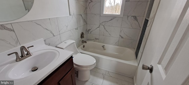 full bath featuring marble finish floor, tile walls, bathing tub / shower combination, toilet, and vanity