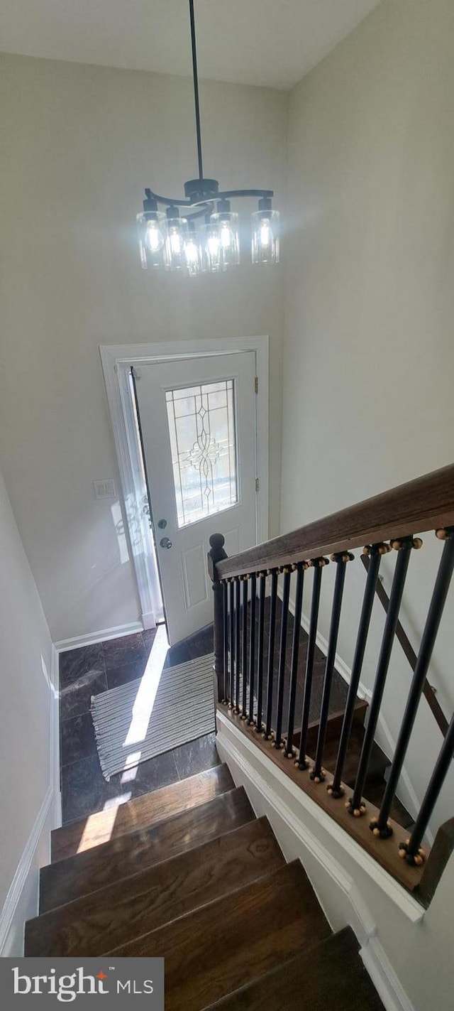 entrance foyer with baseboards and stairway