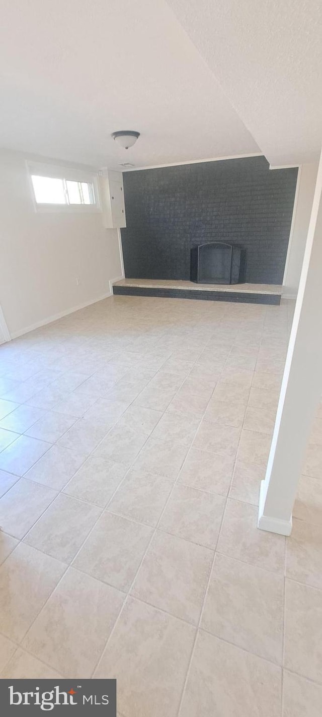 interior space with light tile patterned floors and baseboards