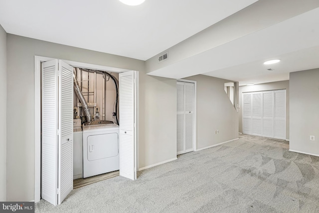 interior space featuring carpet floors, visible vents, washer and clothes dryer, and baseboards