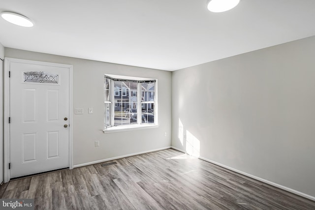 entryway featuring wood finished floors, visible vents, and baseboards