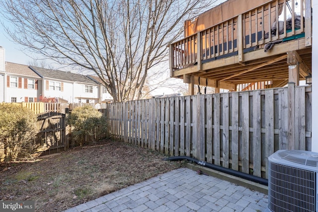 view of yard featuring a fenced backyard, a patio area, and cooling unit