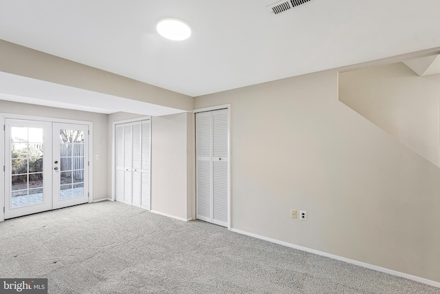 unfurnished bedroom featuring baseboards, visible vents, access to exterior, carpet flooring, and french doors