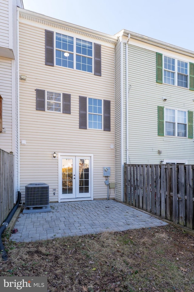 back of property featuring a patio area, fence, central AC, and french doors