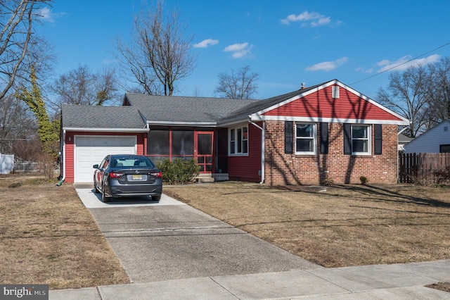 ranch-style home featuring a front yard, brick siding, driveway, and an attached garage