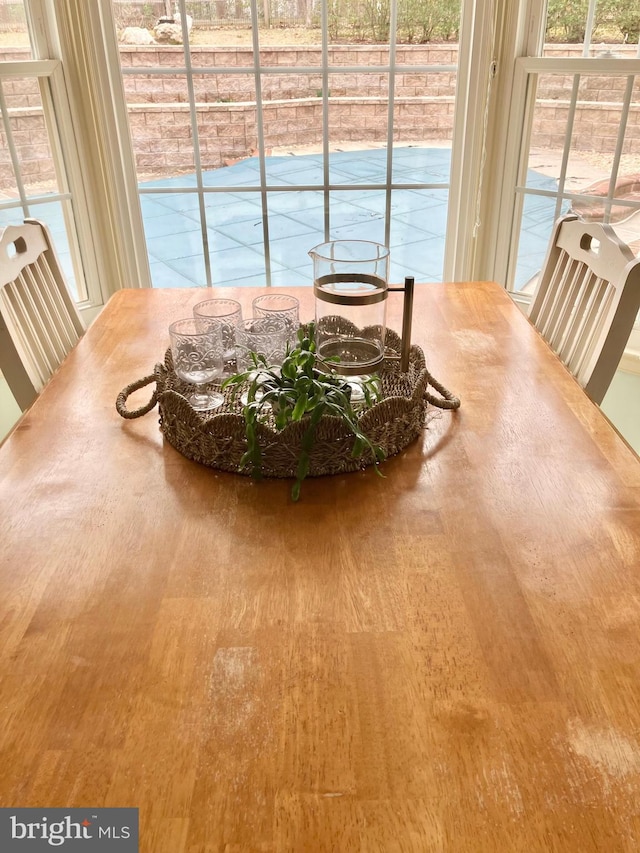 dining area with plenty of natural light and wood finished floors